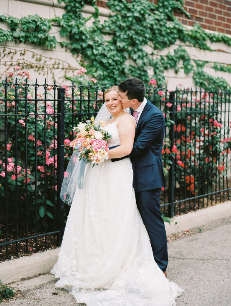 Chicago wedding at Galleria Marchetti - Bride and Groom are posing in front of flowers